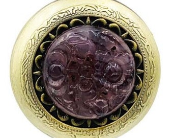 May include: A gold-tone pocket watch with a chain. The watch face has a purple, ornate design.