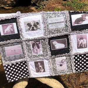 May include: A black and white quilt with a patchwork design featuring photos of dogs. The quilt has a quote about dogs in the center. "A dog is a whole lot of love wrapped in fur." "More than just a pet, they fill the heart and home with love."