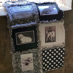 May include: A black and white quilt with a patchwork design. The quilt features photos of dogs and the text "A dog is a bundle of fur, love wrapped in fur."  "Moic, Cassie, Mindy, Chies, Flo, Liln, Fanny & Arnie"