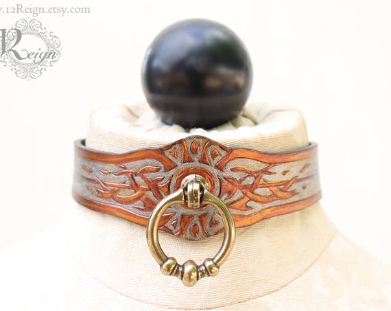 Fetish leather collar- Tribal Sun design. Featuring fitted grommet and post closure
