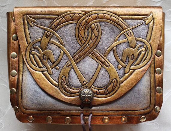 Leather pouch- dragon serpent. Dual celtic dragon serpent design with custom concho closure. Now available in metal-like gold & silver tones