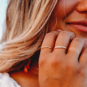 Woman wearing 14k gold filled ultra thin rings