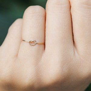 Woman wearing 14k gold filled knot ring