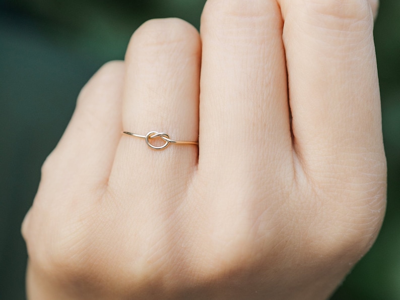 Woman wearing 14k gold filled knot ring