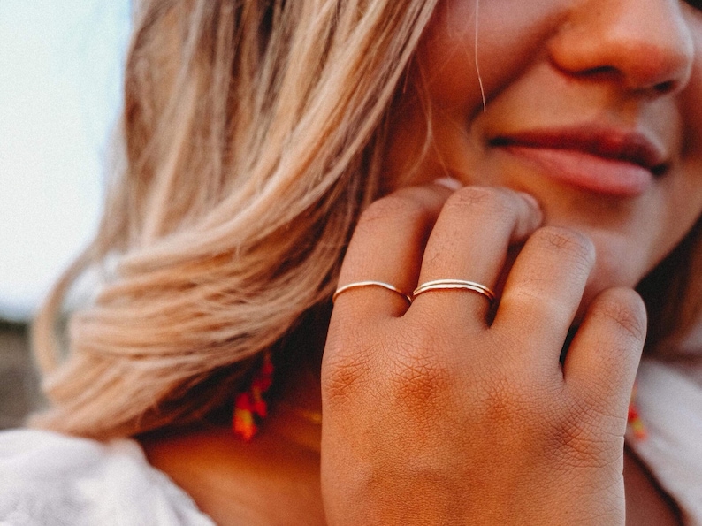 Woman wearing 14k gold filled ultra thin rings