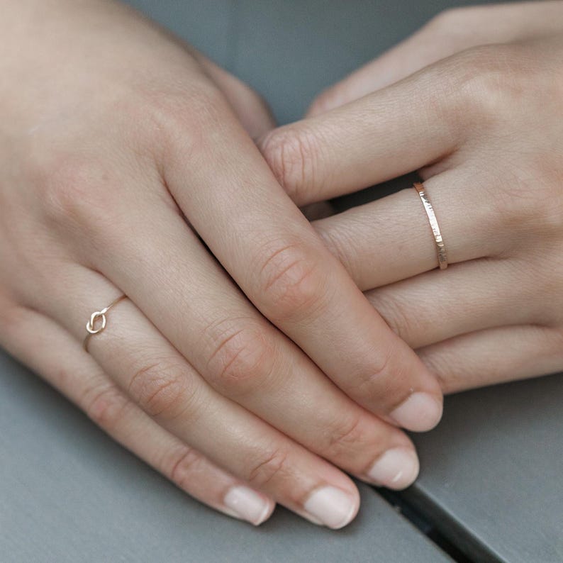 Woman wearing 14k gold filled thick sparkle ring and various other Laurel Elaine Jewelry