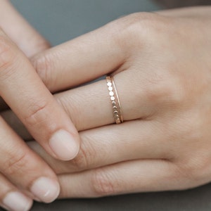 Woman wearing 14k gold filled ultra thin rings and various other Laurel Elaine Jewelry