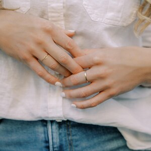 Woman wearing 14k gold filled thick sparkle ring and various other Laurel Elaine Jewelry