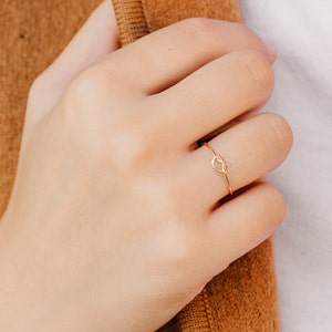 Woman wearing 14k gold filled knot ring