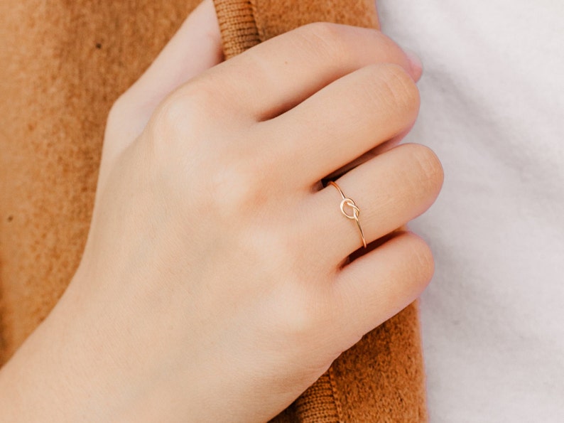 Woman wearing 14k gold filled knot ring