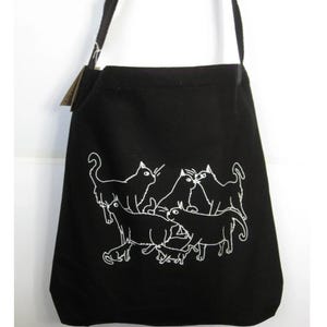 em&#39;s Cats - Sling Bag in Natural or Blasck Canvas with original art and modeled by emily burke