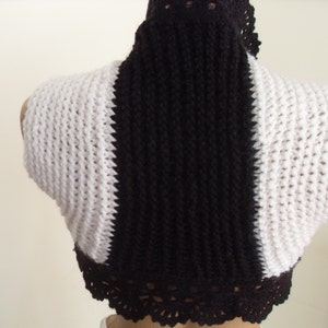 Knitted  shrug in shades of black and white.