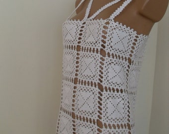 Delicate white lace dress, hand crocheted. Woven from mercerized cotton.