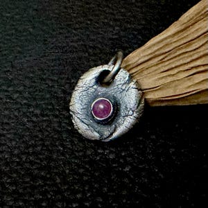 oxidized sterling silver ruby pendant round to oval shape. rustic and irregular