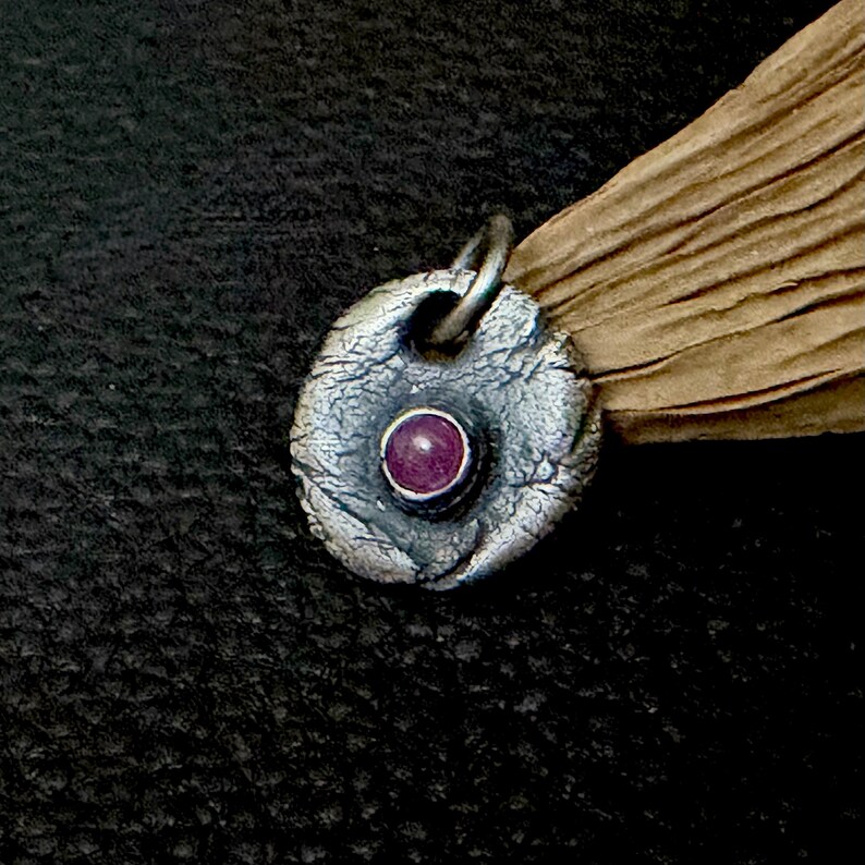 oxidized sterling silver ruby pendant round to oval shape. rustic and irregular