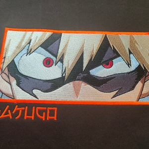 May include: A close-up of an embroidered image of a character with spiky blonde hair and red eyes. The character is wearing a black mask and has a serious expression. The image is surrounded by an orange border and the text "BAKUGO" is below the image.