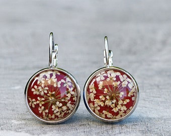 Earrings with real blooms on burgundy