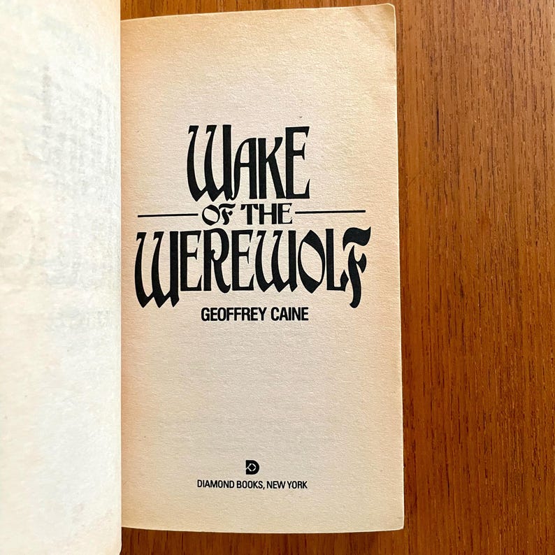 May include: Open book page featuring the title "Wake of the Werewolf" in a gothic font. The author's name, Geoffrey Caine, is below the title. The Diamond Books, New York logo and text are at the bottom.