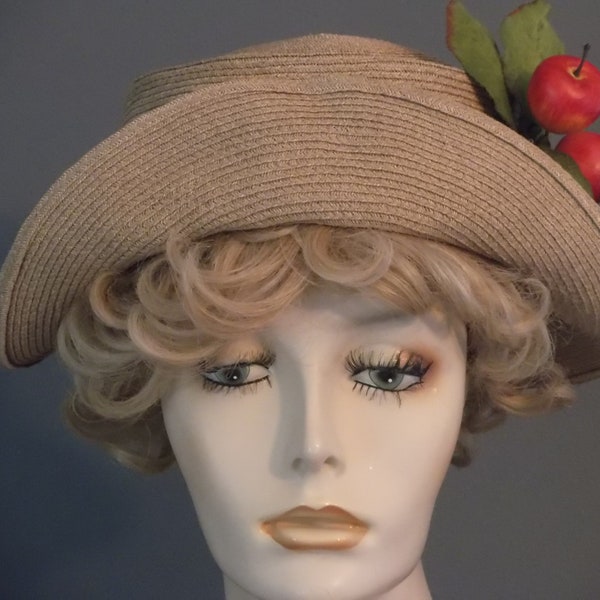 beige straw hat with apple embellishment, olive green ribbon band, apple with leaves, small beige upbrim in front, vintage look, summer hat