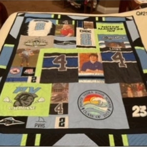 May include: A blue and black quilt with various patches, including photos, sports jerseys, and school logos. The quilt features the text "Ponte Vedra High School Class of 2017", "PV Lacrosse", "PVHS", and "Choe 2".