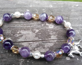 May include: A purple amethyst and pearl bracelet with a silver horse charm. The bracelet features alternating amethyst, pearl, and crystal beads.
