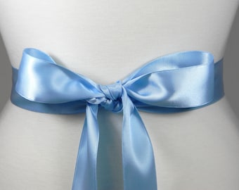 white dresses with blue satin sashes