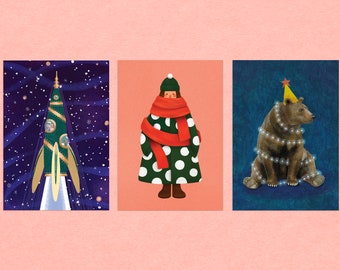 Postcard Set Of Three A6 Christmas Cards - Illustrated Laika in Space, Girl in Big Fluffy Coat, Bear in Lights - Matte Finish