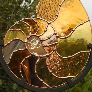 Ammonite Sun Catcher.Mixed Copper & Amber Stained Glass.Real Sliced Ammonite Centre.Hanging or Standing Version. Original Design.All Unique.