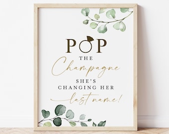 May include: A printable sign with a green leafy design and the text "Pop the Champagne She's Changing Her Last Name!"
