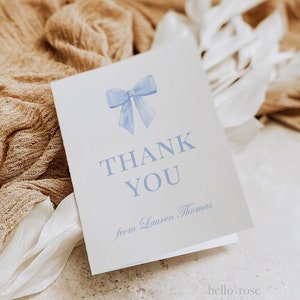 May include: A white thank you card with a blue watercolour bow and the text "THANK YOU from Lauren Thomas".