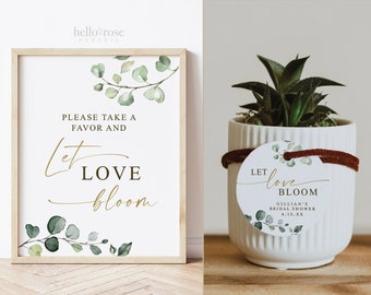 May include: A white sign with green watercolor eucalyptus leaves and gold lettering that reads "Please take a favor and let love bloom". A small potted succulent plant with a white round tag that reads "Let love bloom Gillian's Bridal Shower 4.15.XX" with green watercolor eucalyptus leaves.