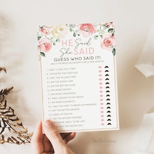 May include: A pink and white floral themed printable game card with the text "He Said She Said Guess Who Said It! Was it the bride or groom? Circle one or both."  The card has a list of 13 questions about the bride and groom, with a pink circle and a brown mustache next to each question.