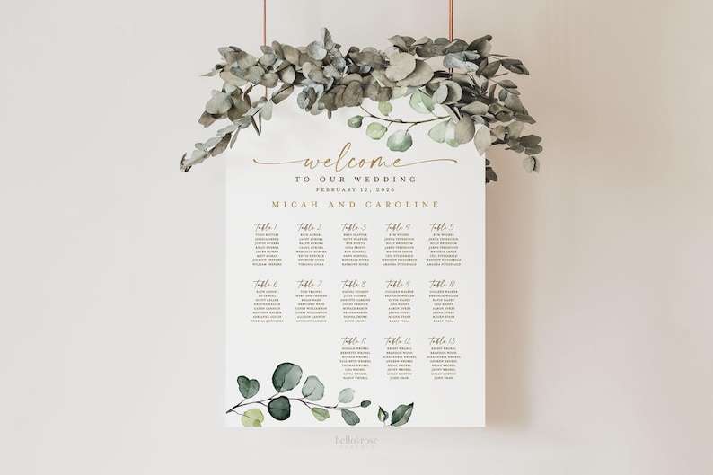 May include: A wedding seating chart with a eucalyptus and greenery design. The chart is printed on white cardstock and features the text "Welcome to our wedding, February 12, 2023, Micah and Caroline".