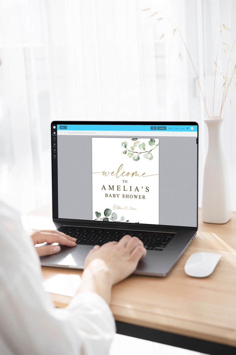 Puede incluir: Un dise&ntilde;o digital para un cartel de bienvenida de baby shower con un dise&ntilde;o de rama de eucalipto en acuarela y texto dorado que dice "Bienvenido al baby shower de Amelia, 22 de octubre de 2023".