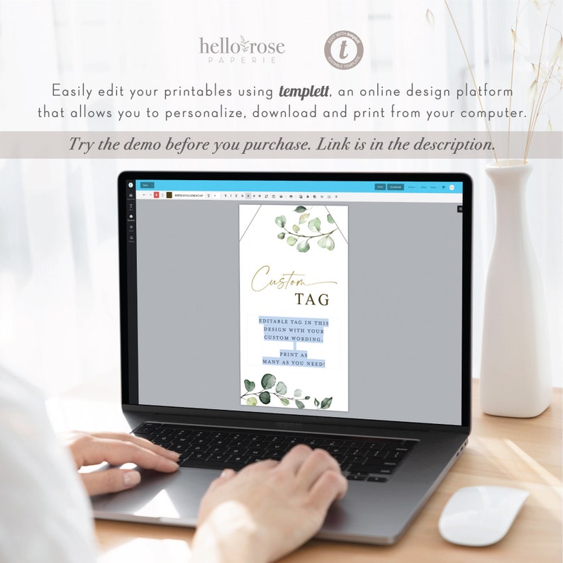 May include: A laptop screen displaying a digital design template for a custom tag with a watercolor eucalyptus leaf design. The text on the screen reads "Custom Tag" and "Editable tag in this design with your custom wording. Print as many as you need!"