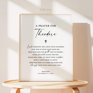 May include: A black and white printable prayer for Theodore, with a cross and the text "Lord, surround this child with goodness; lead him in your light each day. Help him walk the path you've chosen: Guide his steps along the way. Teach him, Lord, to trust your wisdom with a faith from up above. Keep him from all harm and bless him always with your grace and love. Baptized November 12, 20XX"