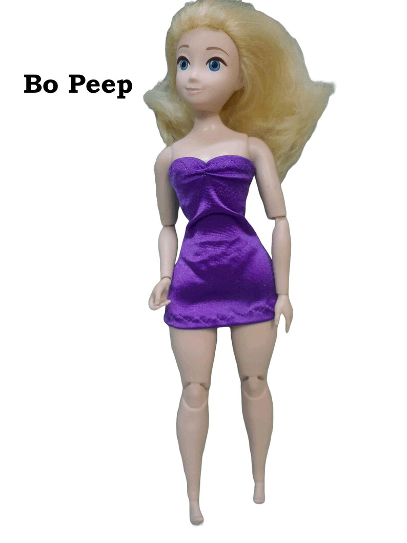 May include: Bo Peep doll with blonde hair wearing a purple strapless dress made from satin finish charmeuse spandex.