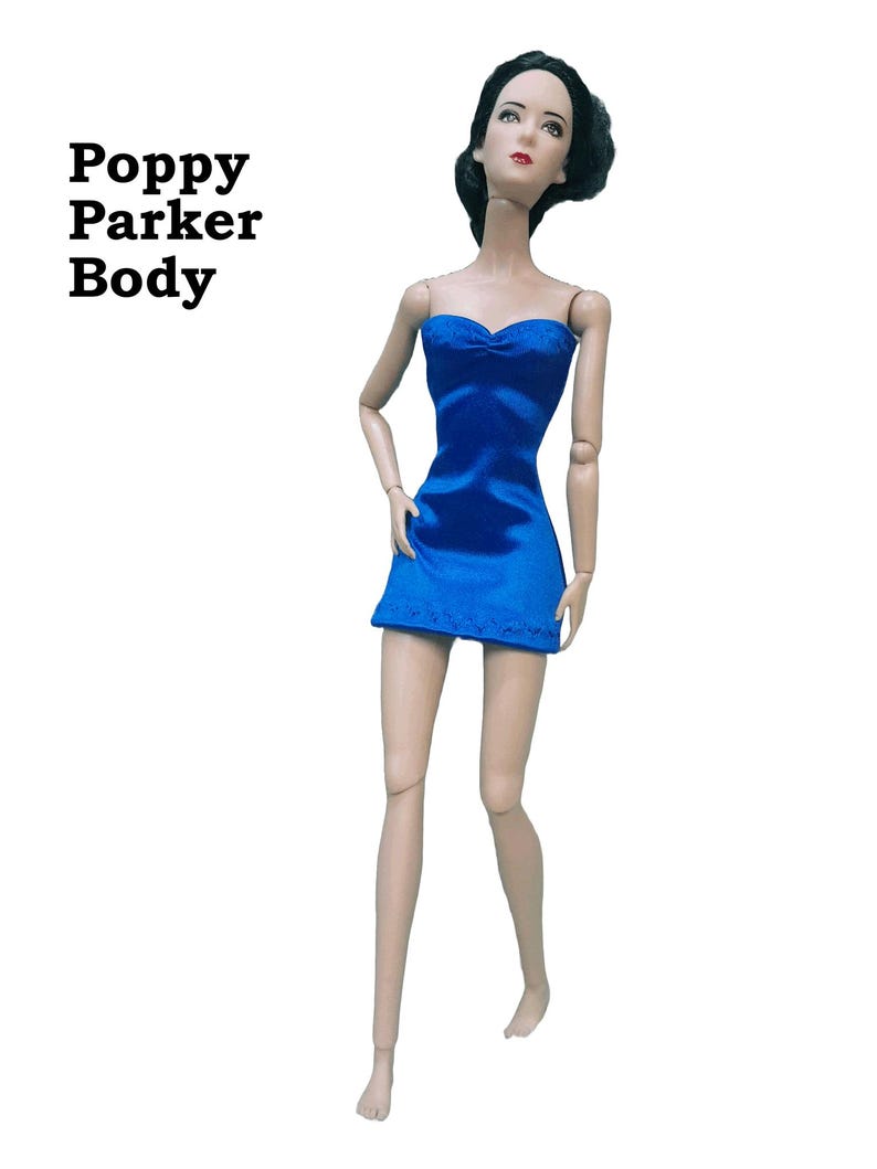May include: A doll wearing a blue strapless satin finish spandex mini dress