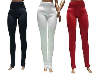 May include: Three pairs of doll leggings in black, white, and red. Each pair features a high-waisted, form-fitting design with a smooth texture, extending down to the ankle area, presented on doll figures against a plain white background.