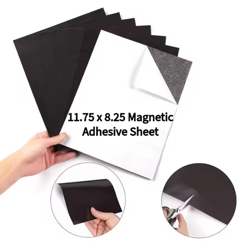 May include: A stack of black and white 11.75 x 8.25 inch magnetic adhesive sheets. The image shows a hand holding the sheets, with a corner of one sheet peeled back to reveal the magnetic backing. Additional detail images show the sheets being cut.