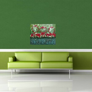 May include: Abstract art print with a green background and red, white, and blue circles. The print is framed and hanging on a green wall above a green sofa.