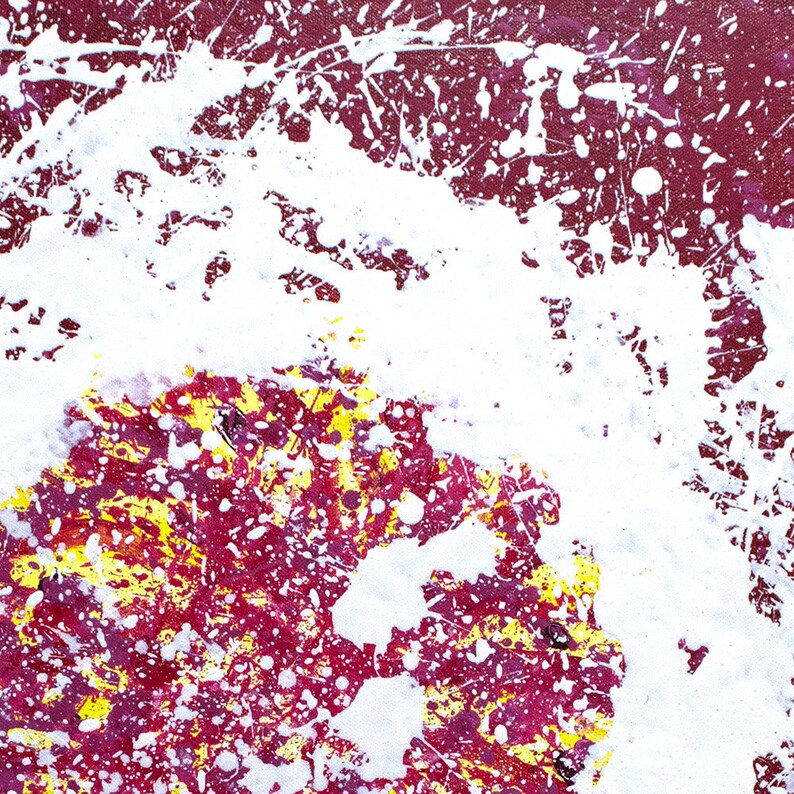 May include: Abstract painting with white, red, and yellow paint splatters on a canvas. The white paint is concentrated in the centre of the canvas, creating a circular shape.