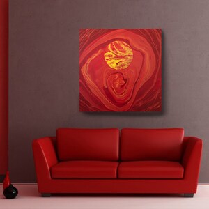 May include: Abstract painting with red and gold swirls and a large gold circle in the center.
