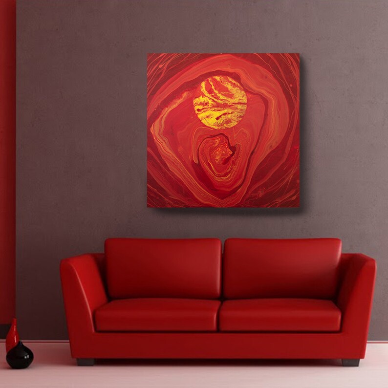May include: Abstract painting with red and gold swirls and a large gold circle in the center.