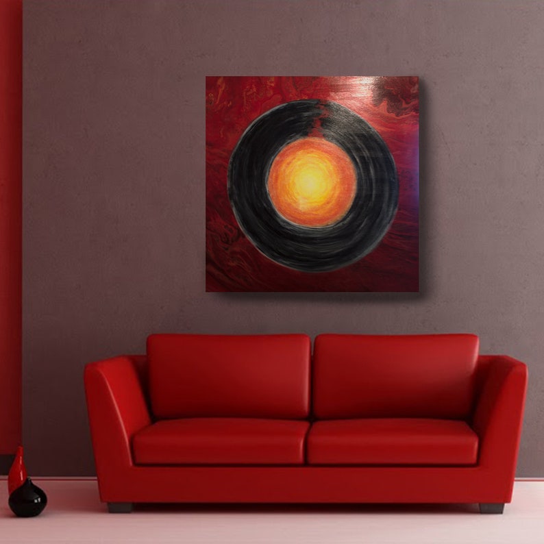 May include: Abstract painting with a black circle in the center, surrounded by a red and orange ring. The background is a dark red.