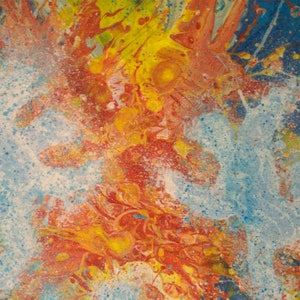 May include: Abstract painting with a mix of yellow, orange, red, and blue paint splattered on a white background.