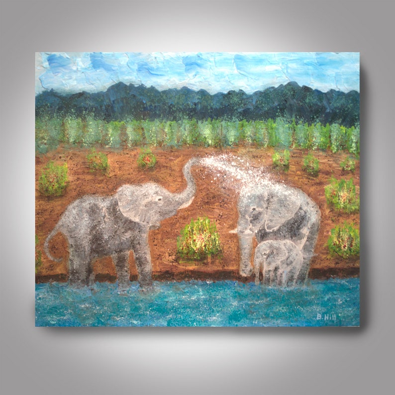 May include: A painting of three elephants in a grassy field by a blue river. The elephant in the foreground is spraying water from its trunk. The elephants are gray and white.