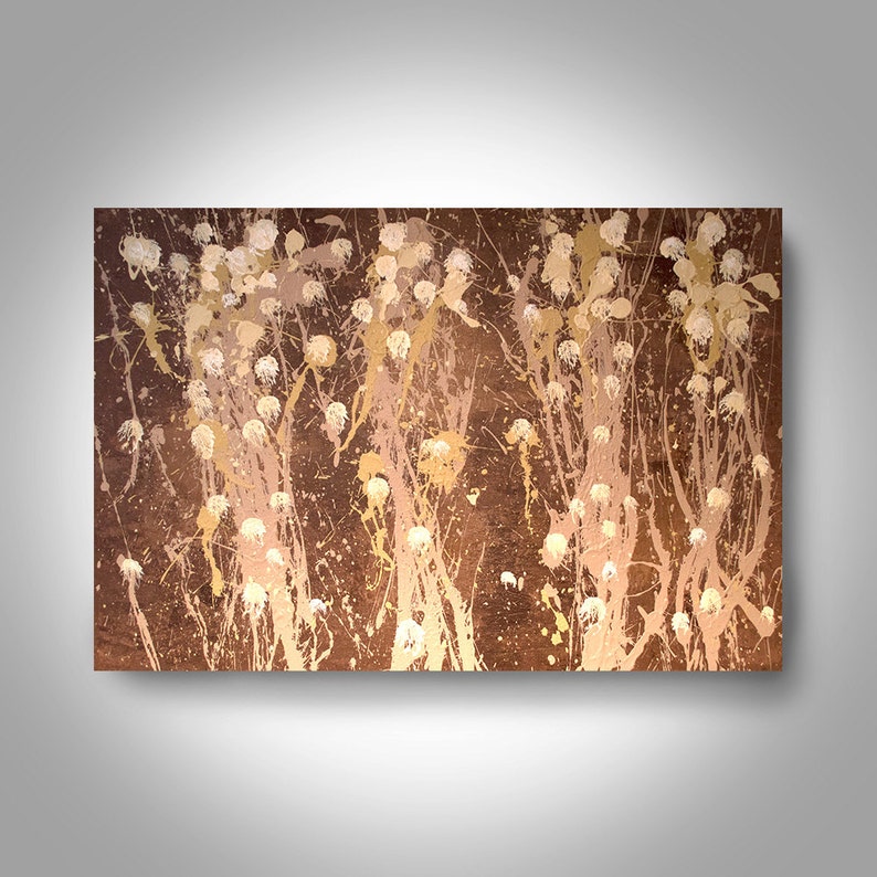 May include: Abstract painting with a brown background and white and gold splatters. The splatters are arranged in a pattern that resembles a forest of trees.