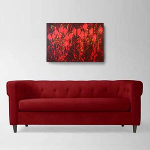 May include: Abstract painting with red, yellow, and black paint splatters on a dark background. The painting has a modern and contemporary style.