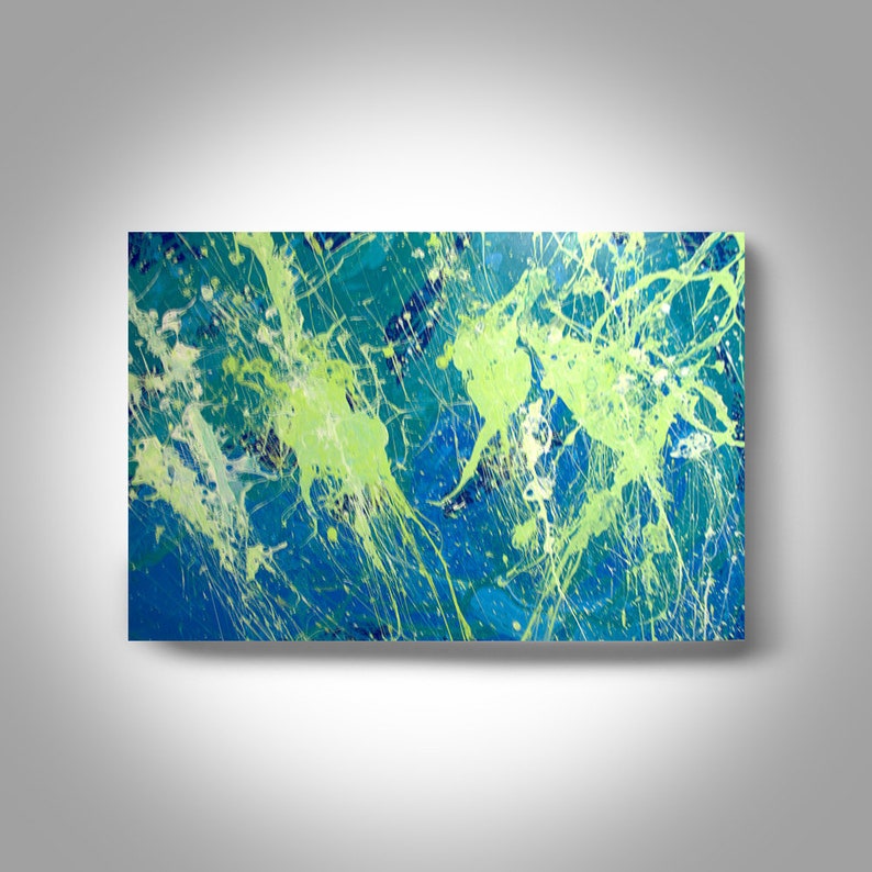 May include: Abstract painting with a vibrant color palette. The artwork features a deep blue background with splashes of light green, white, and teal paint. The paint is splattered across the canvas, creating a dynamic and energetic composition.